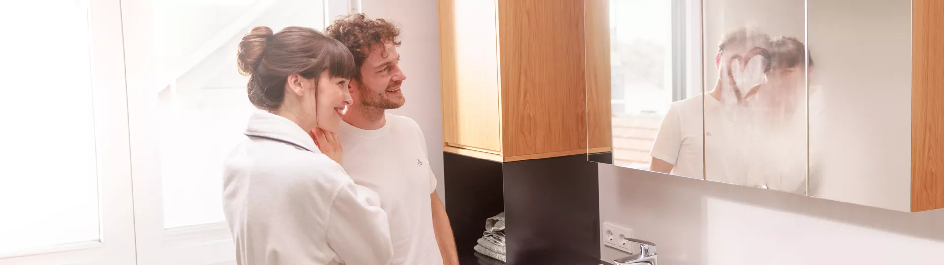 Couple in bathroom looking in the mirror